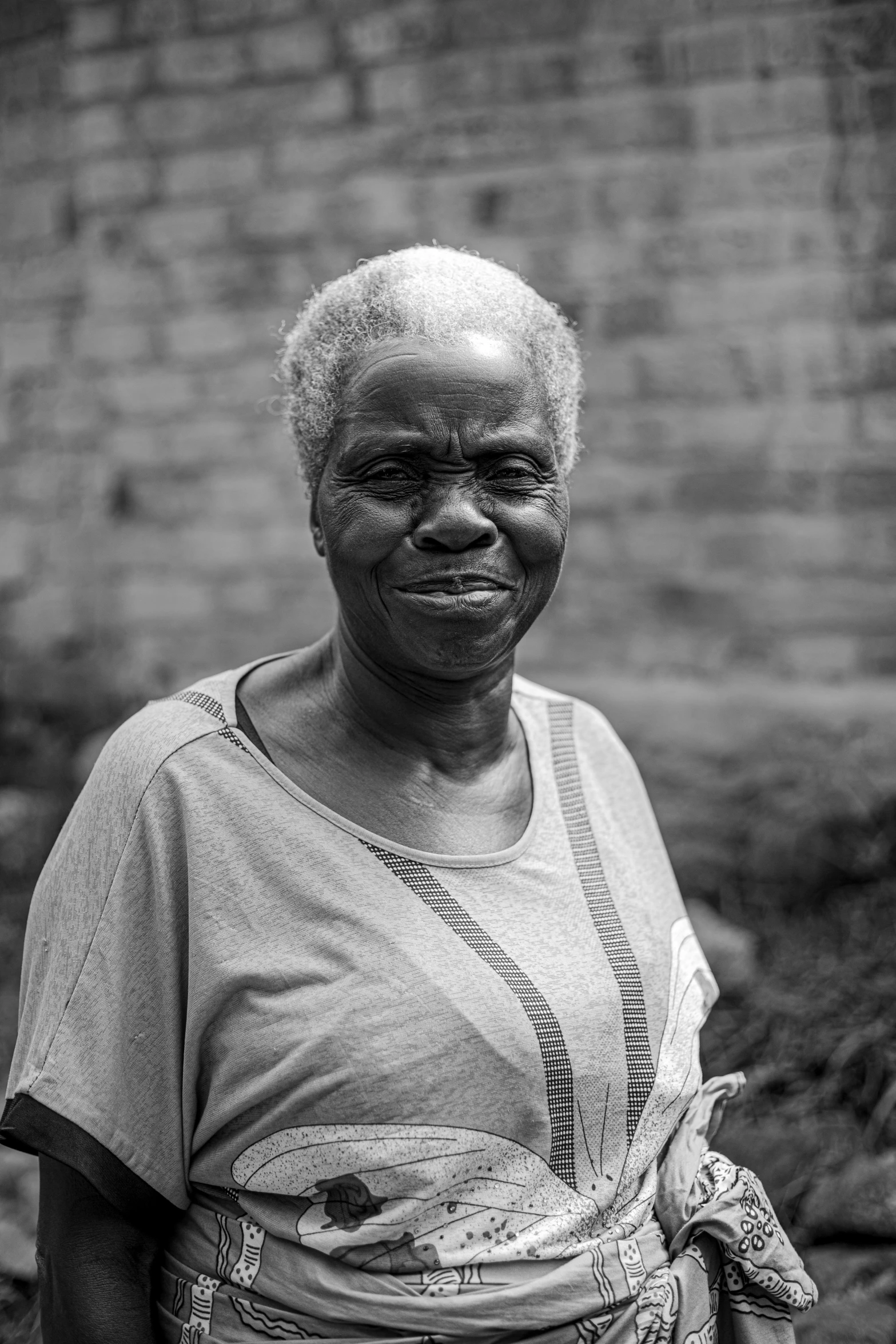 a smiling woman in africa poses for a pograph