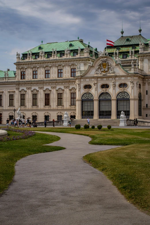 an ornate building has green roof tops