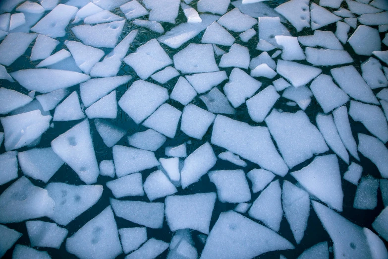 a snow covered surface with chunks of ice