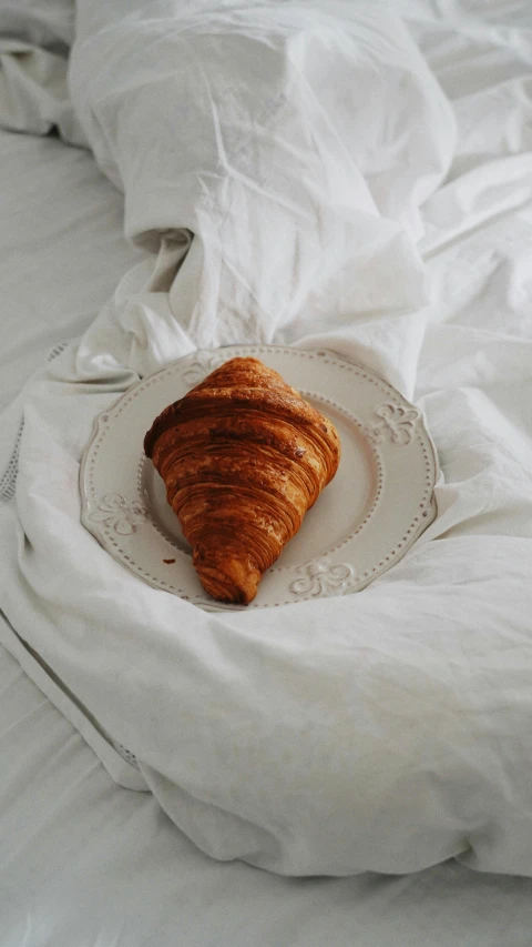 a breakfast on a bed on the side of a plate