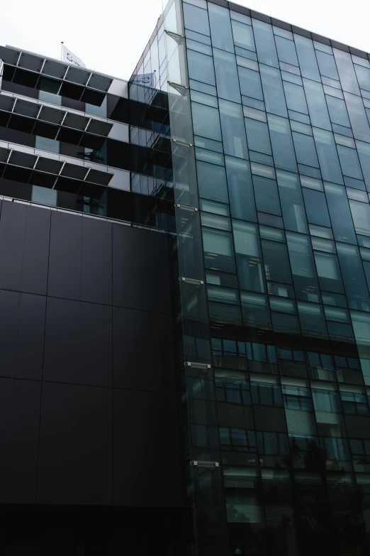 a black glass building and a clock in front