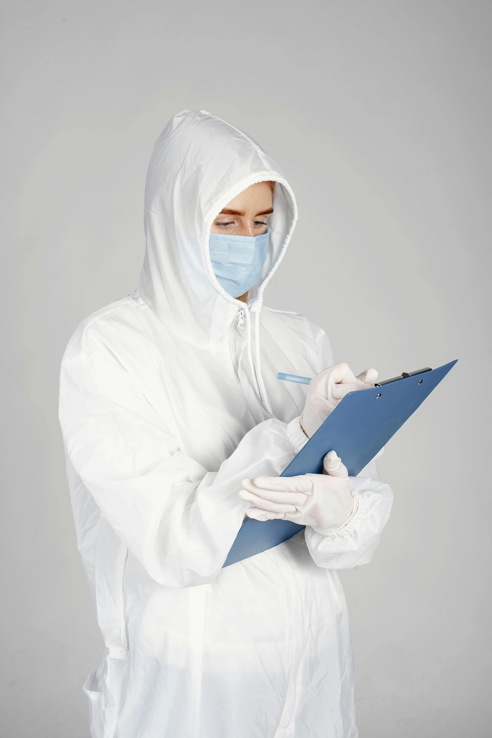 a man in a white protective suit holding soing