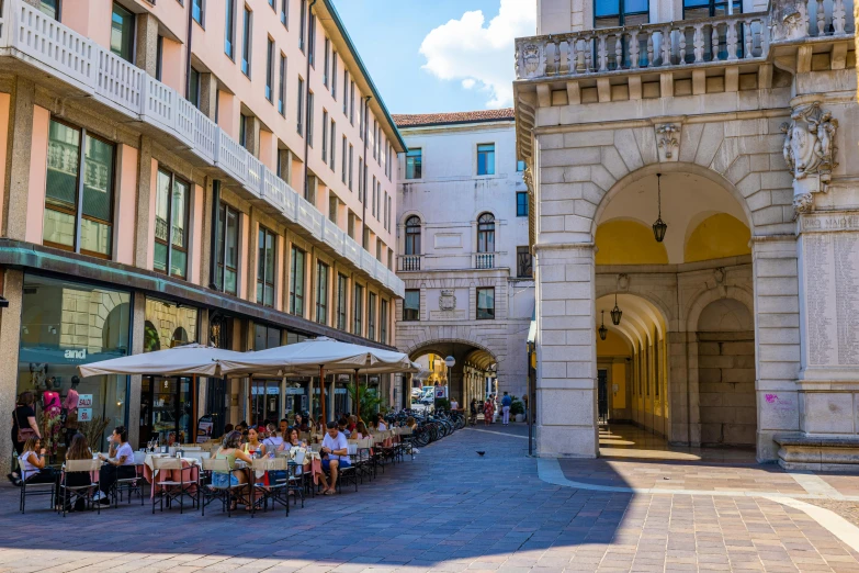 a long sidewalk lined with tables and chairs