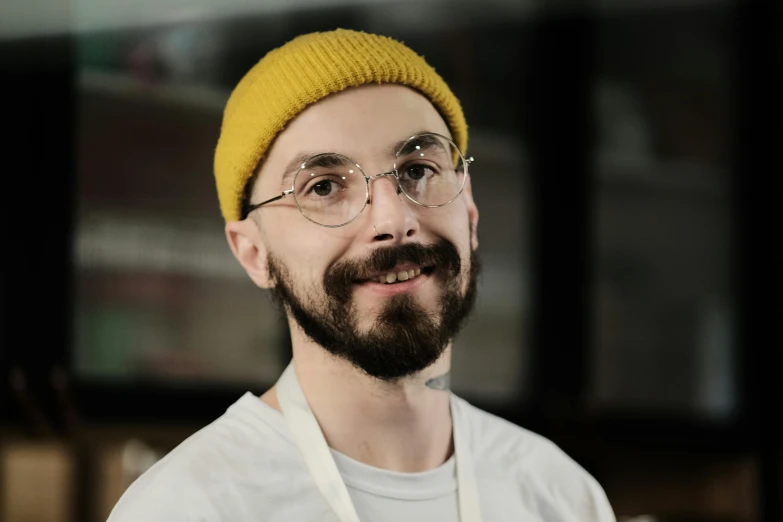 a man in glasses and a yellow hat