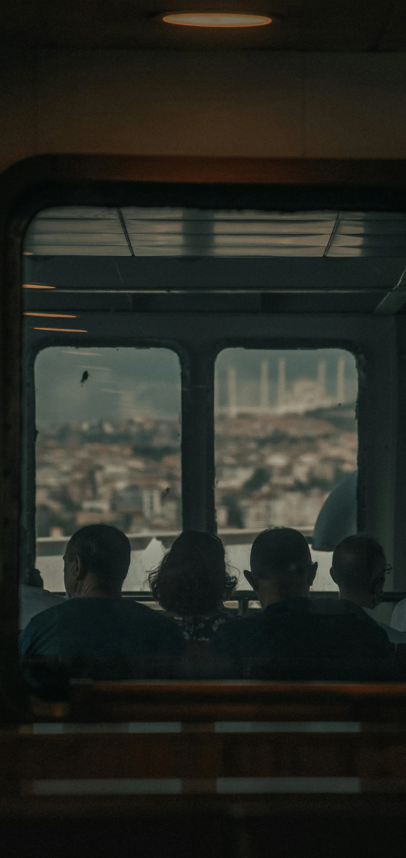 people are riding on a bus with a view of the city