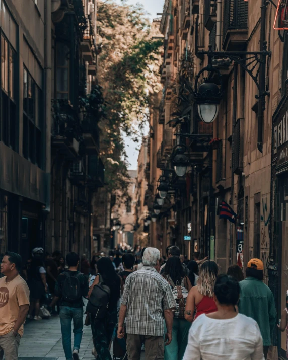 a crowded street with lots of people walking along it