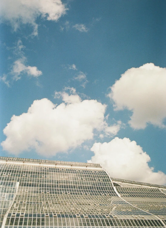 a picture of the sky above a glass building