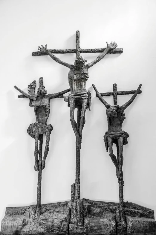 a group of three small wooden crucifixs standing upright