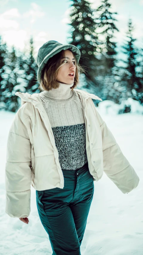 the woman is walking through the snow in her coat