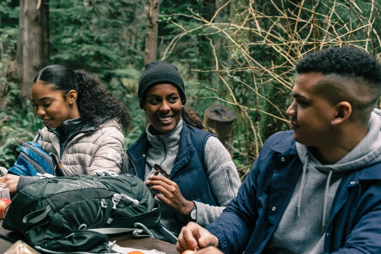 a group of people eat while sitting around tables