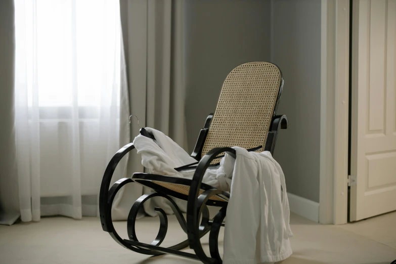 a rocking chair with clothes dd up inside