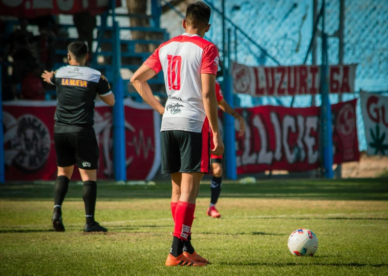 two soccer players standing next to each other while playing soccer