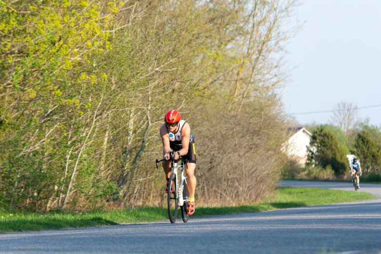 the bicyclist is wearing a helmet and a helmet