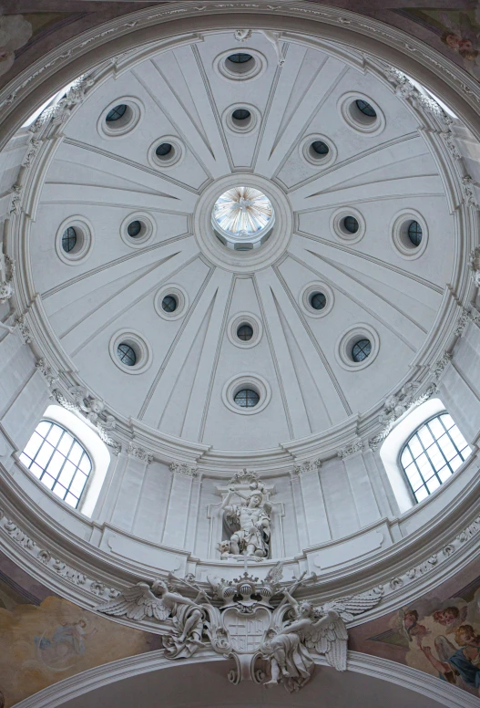 a room that has a clock on the ceiling and there is a domed ceiling