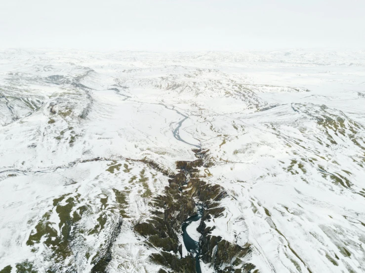 aerial po of snow covered mountains and forest