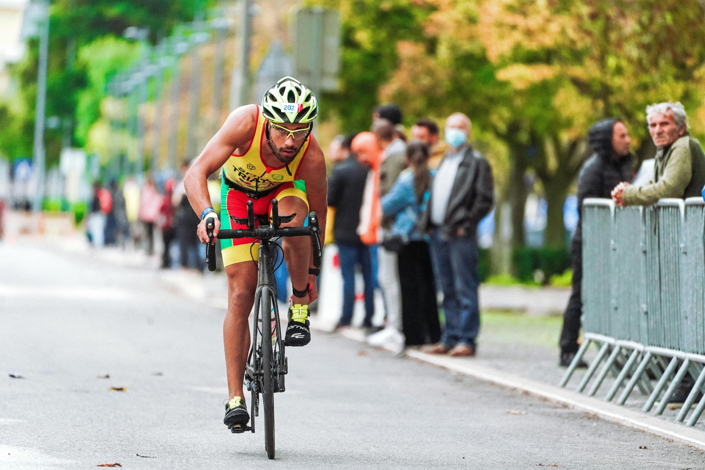 a man riding a bicycle on top of a road