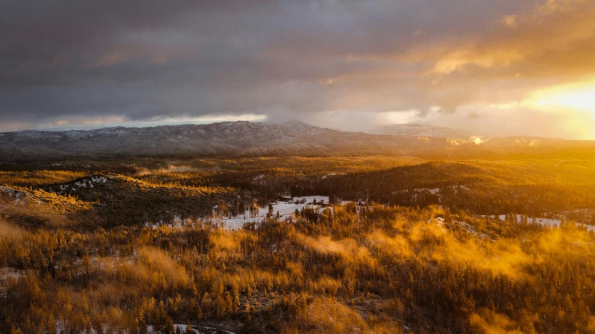 the sun is shining through the clouds and snow