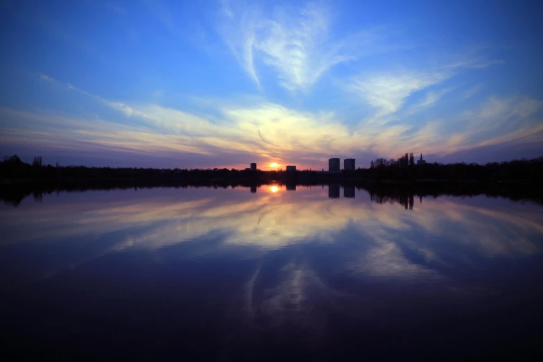 a large body of water with a sky above it