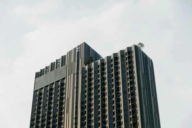 two large buildings against a blue sky with clouds