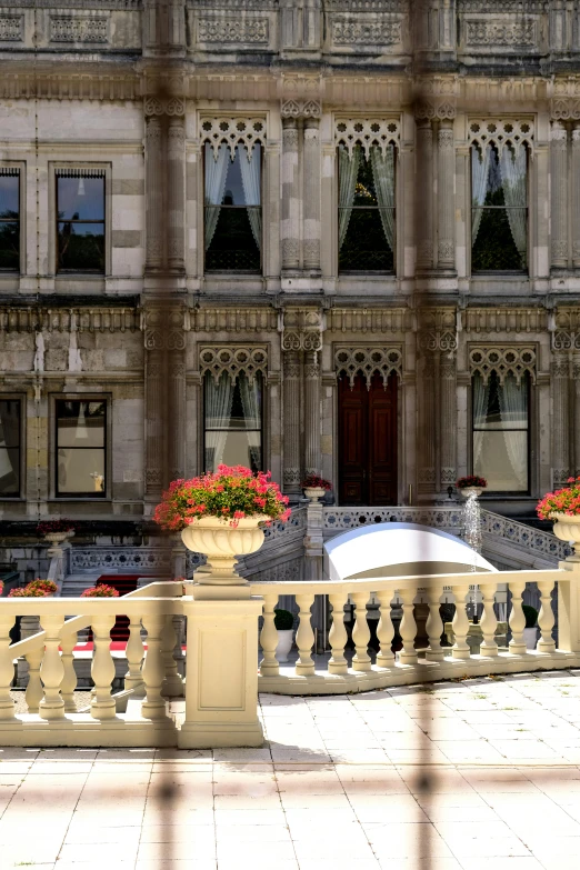 the building has two large pillars and flowers outside