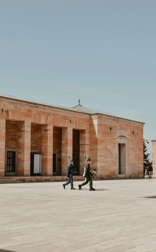 two people standing next to each other outside an old building