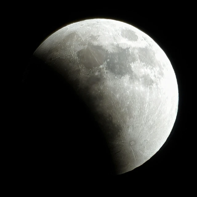 the moon can be seen in front of a black background