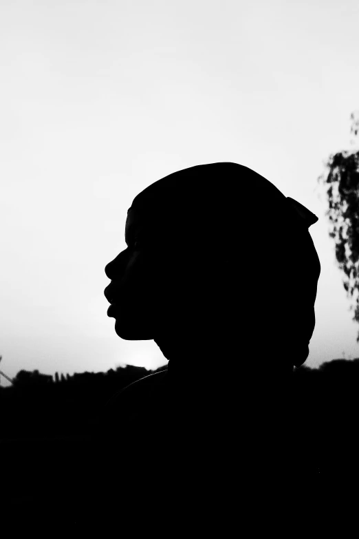 a man in silhouette holding a frisbee on a foggy day