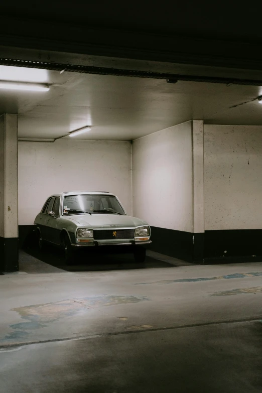 an empty parking garage with a car parked in the area