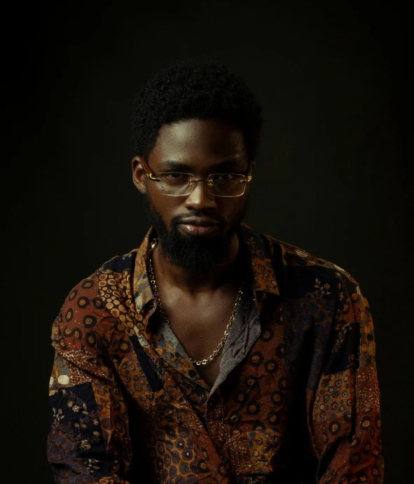 a man with glasses wearing an interesting shirt