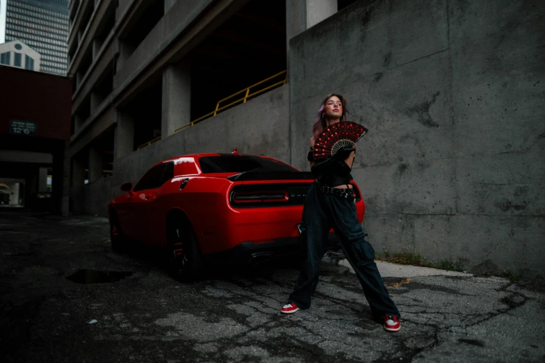 a girl walks next to a parked dodge sr2