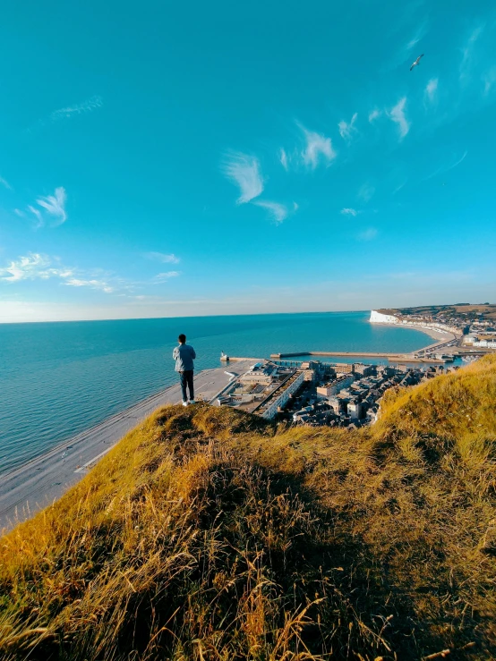 two men look out over a beautiful beach area