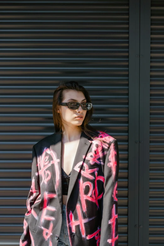 a woman in a jacket with graffiti on the back