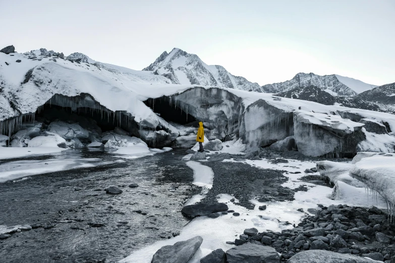 a yellow and white snowy area with rocks