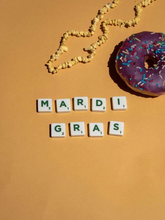 a donut and word spelled with scrabbles and beads