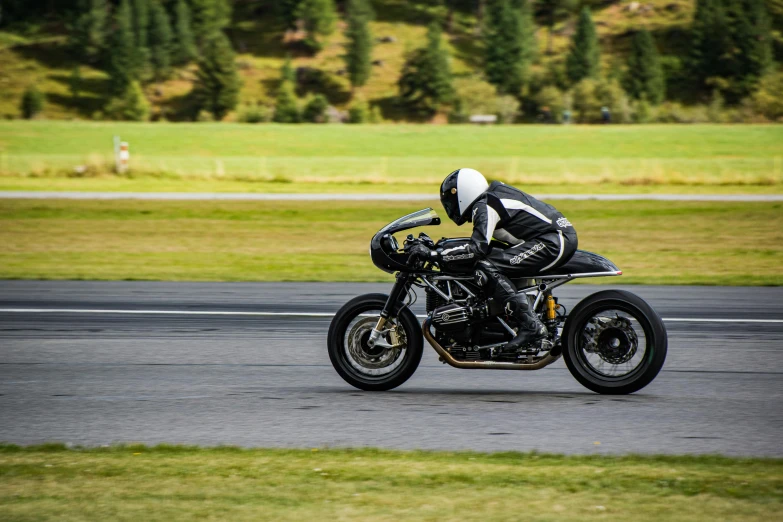 motorcycle rider riding on the asphalt while turning