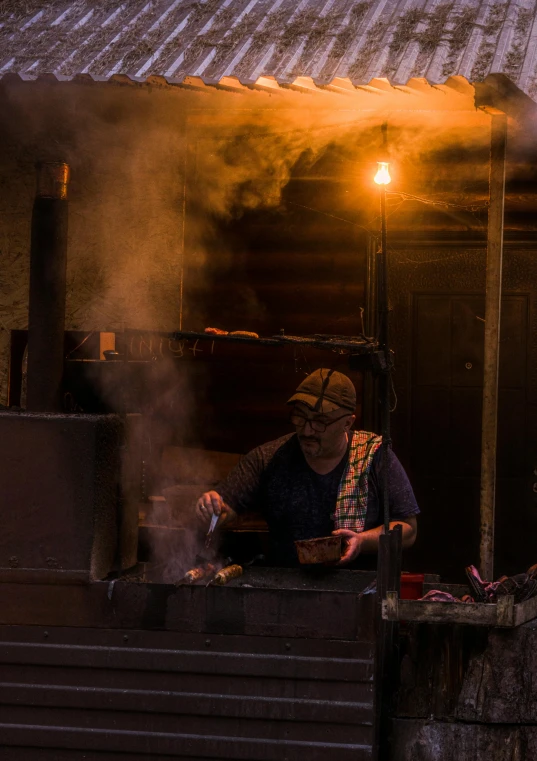 a man cooking in an outdoor oven on the stove