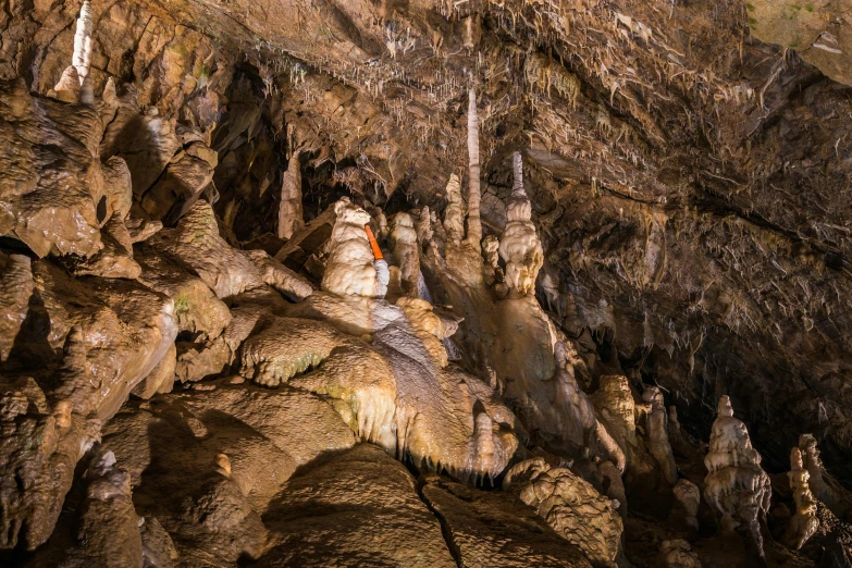 a person wearing red and blue hiking in a cave