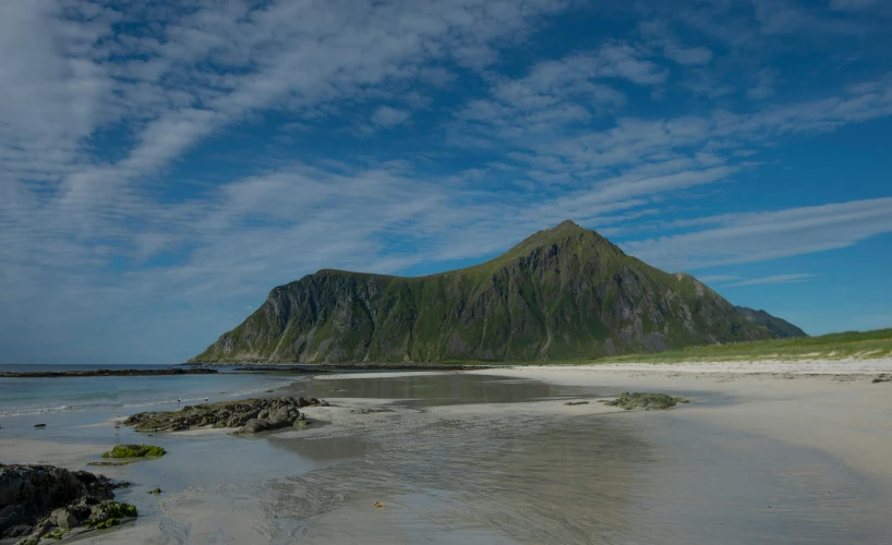 a po of a beach with a mountain in the background