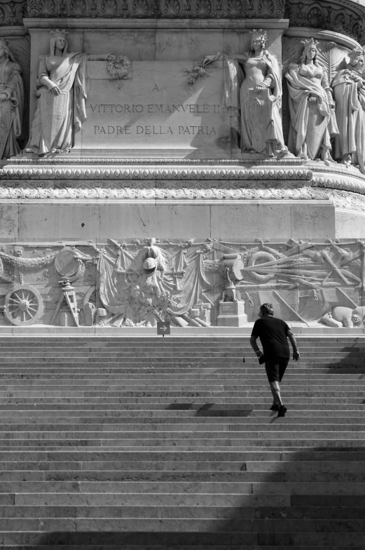 a man is walking down a set of steps near stairs