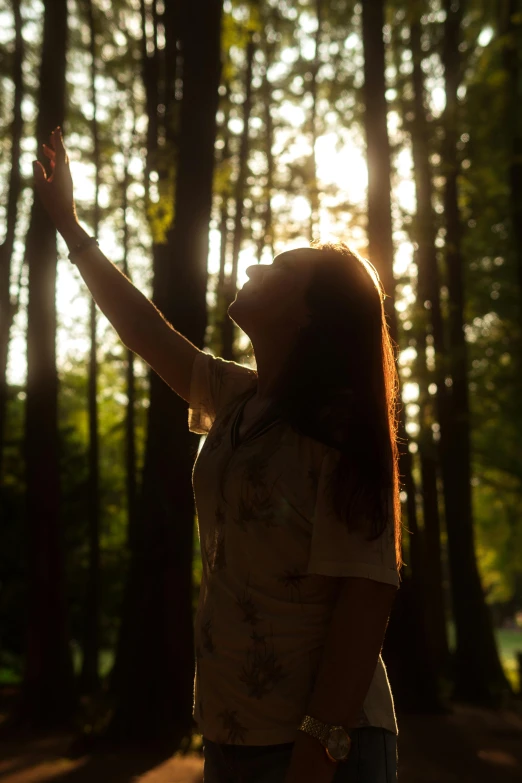 woman reaching up towards a sky with her finger