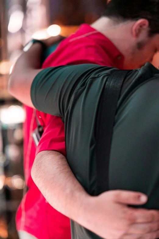 a man standing next to another man holding his arm