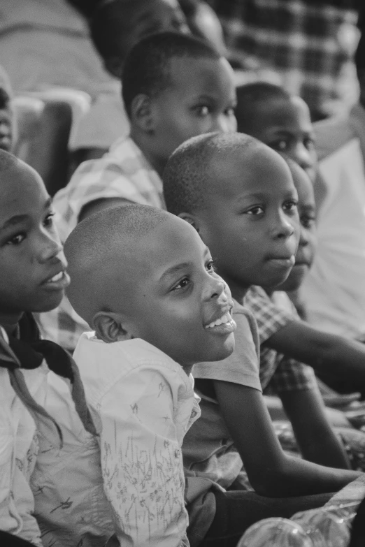 young children in school dress watching soing