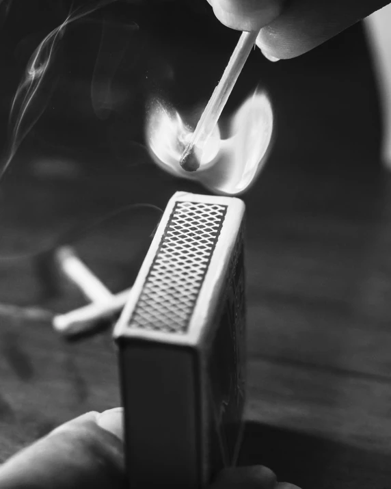 a person smoking a match with a match stick