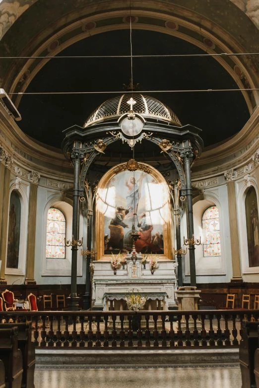 a church interior with a alter and stained glass window