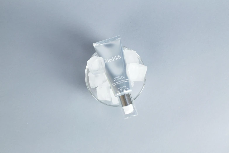 a white product tube on top of a clear plate