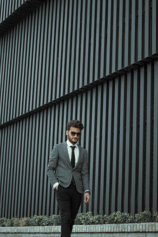 young man dressed in a suit and tie outside an office building