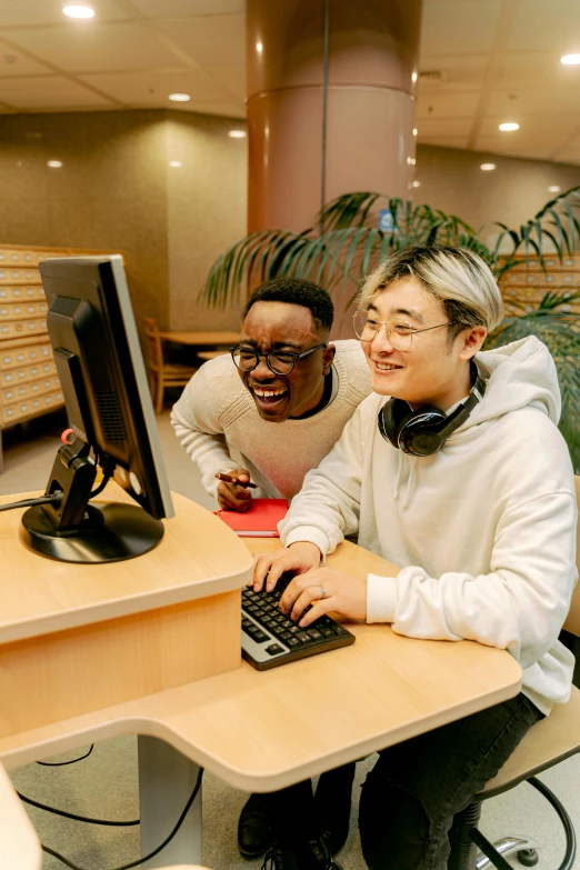 two people looking at a computer screen at a desk