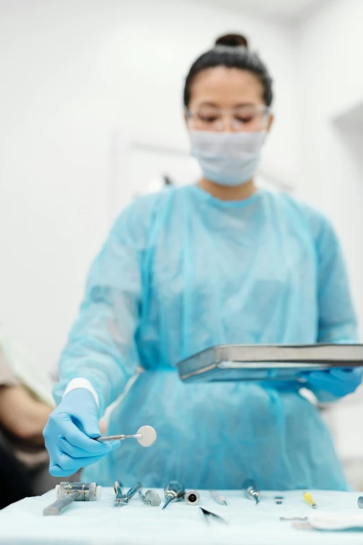 a woman in a surgical mask holding a tablet