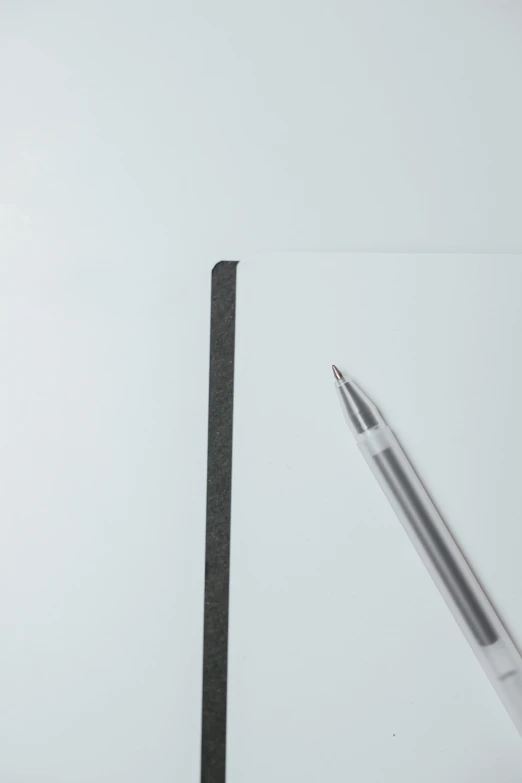 there is a pen next to a piece of paper