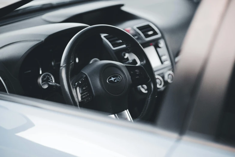 the dashboard of an automobile with the steering wheel and dash stick